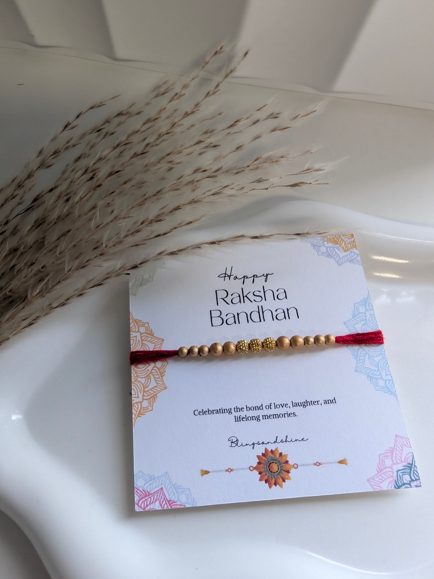 Gold beads thread rakhi